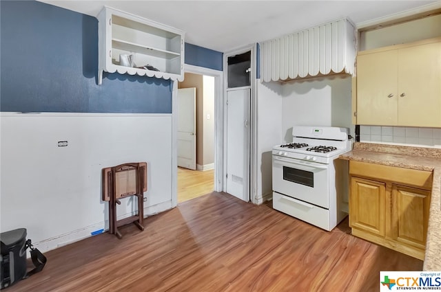 kitchen with light wood-type flooring and white range with gas cooktop