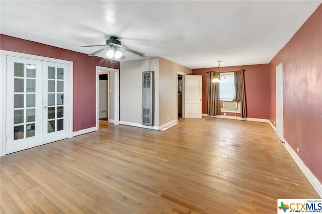 1005 Macarthur St, Victoria, TX 77901 - unfurnished living room featuring light wood-style flooring, a ceiling fan, baseboards, french doors, and cooling unit