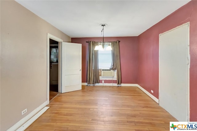 1005 Macarthur St, Victoria, TX 77901 - unfurnished dining area with light wood-style flooring, cooling unit, and baseboards