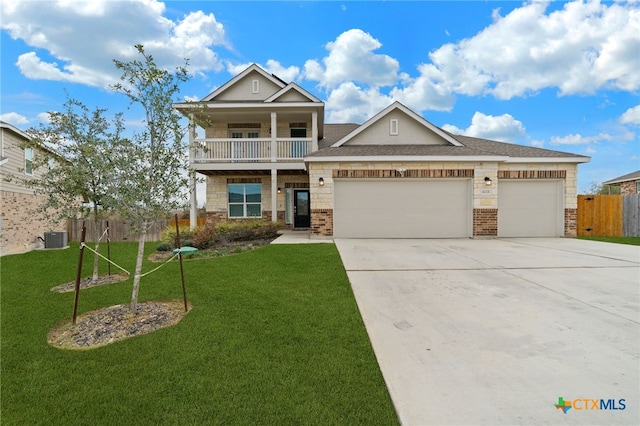 view of front of home with a balcony, a front yard, a garage, and central AC