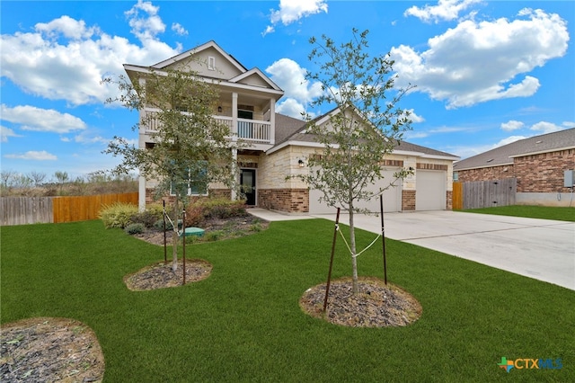 view of front of property featuring a front yard, a balcony, and a garage