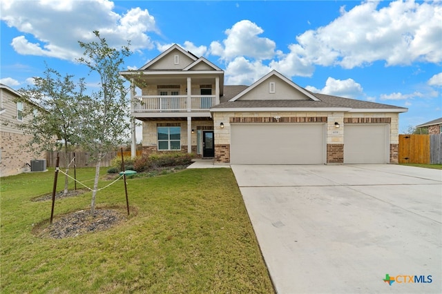 view of front facade featuring a front yard, a balcony, central AC unit, and a garage