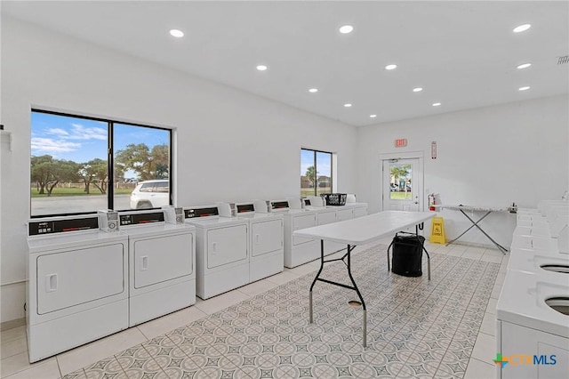 25 Augusta Cir, Aransas Pass, TX 78336 - community laundry featuring separate washer and dryer, light tile patterned floors, and recessed lighting