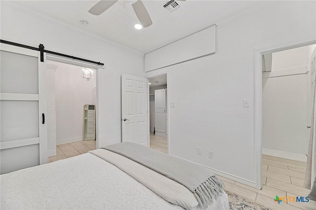 25 Augusta Cir, Aransas Pass, TX 78336 - bedroom featuring crown molding, a barn door, a ceiling fan, and recessed lighting