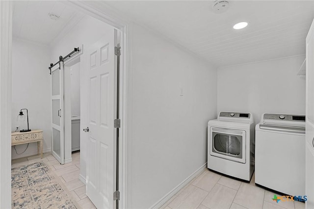 25 Augusta Cir, Aransas Pass, TX 78336 - laundry room with a barn door, washer and clothes dryer, and light tile patterned flooring