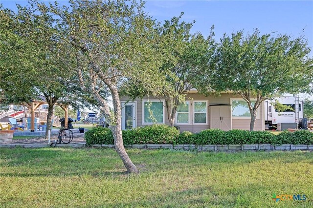 25 Augusta Cir, Aransas Pass, TX 78336 - obstructed view of property featuring a front lawn