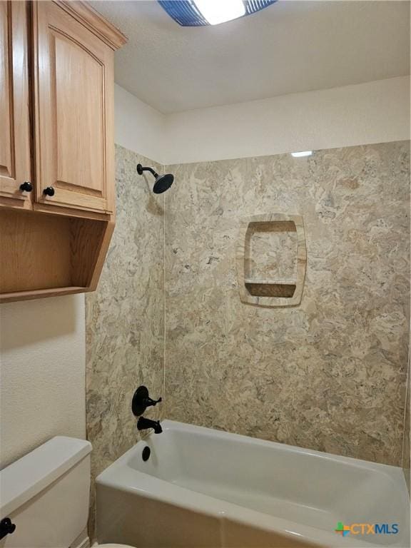 bathroom with tub / shower combination and toilet