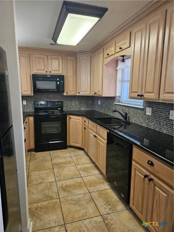 kitchen with a sink, tasteful backsplash, black appliances, light brown cabinetry, and light tile patterned floors