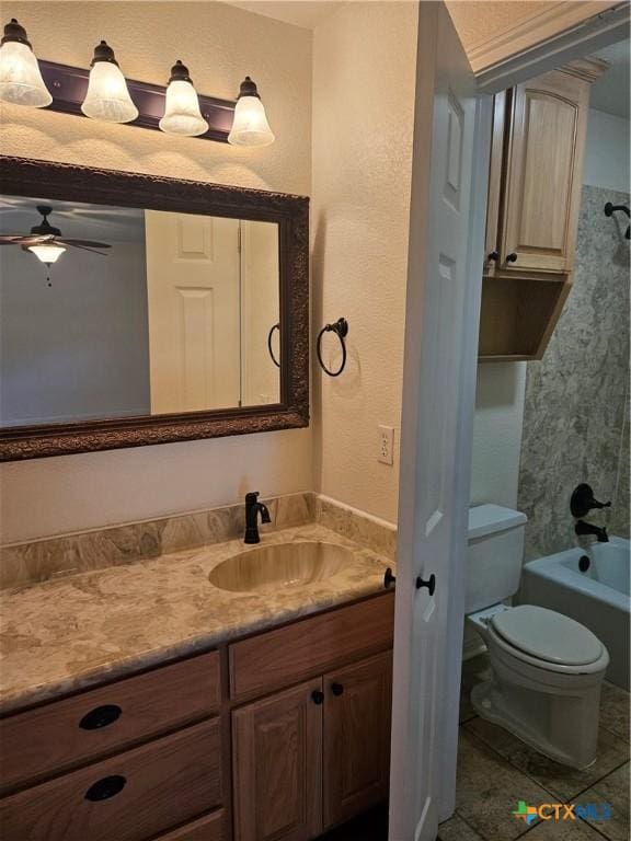bathroom featuring shower / bath combination, toilet, ceiling fan, tile patterned flooring, and vanity