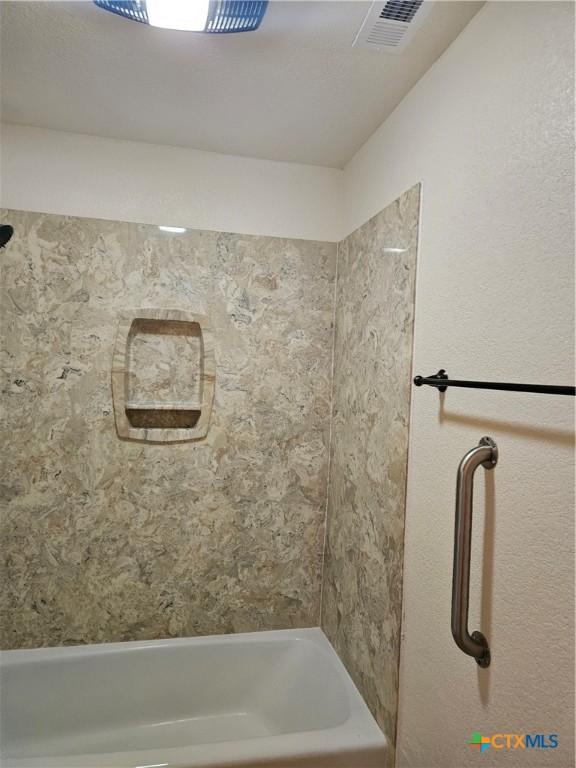 full bath with visible vents and bathtub / shower combination