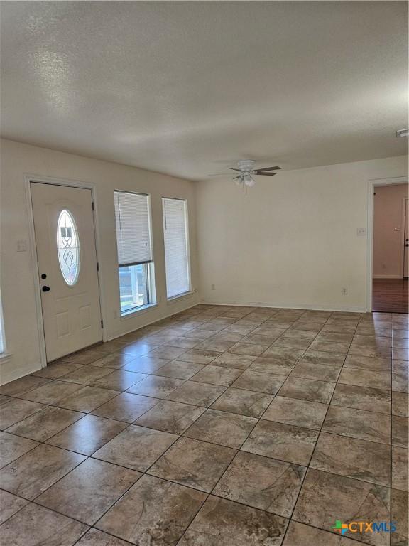 entrance foyer with tile patterned flooring and a ceiling fan