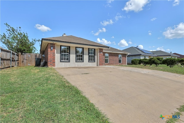 ranch-style home with a front yard