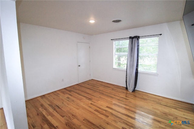 spare room featuring light wood-type flooring