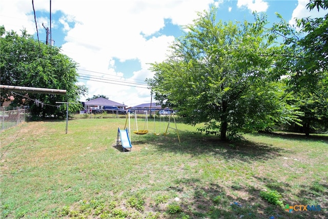 view of yard with a playground and a trampoline