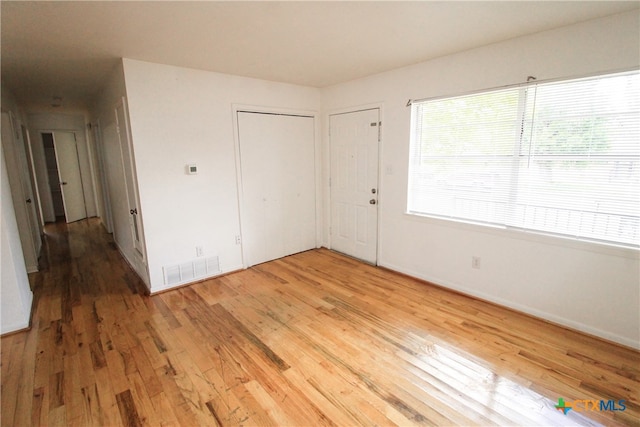 unfurnished bedroom with hardwood / wood-style floors