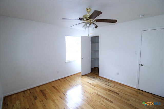 unfurnished bedroom featuring light wood-type flooring and ceiling fan