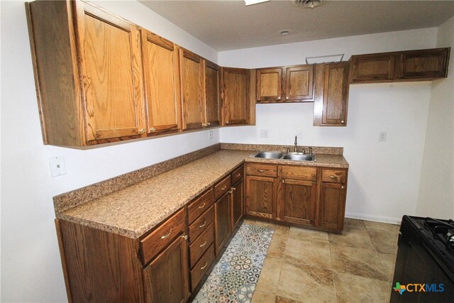 kitchen featuring black range oven and sink