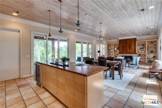 352 Ridge Crest Dr, Seguin, TX 78155 - kitchen featuring wooden ceiling, light tile patterned flooring, butcher block countertops, crown molding, and healthy amount of natural light