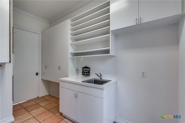 352 Ridge Crest Dr, Seguin, TX 78155 - washroom with a sink, crown molding, light tile patterned floors, and baseboards