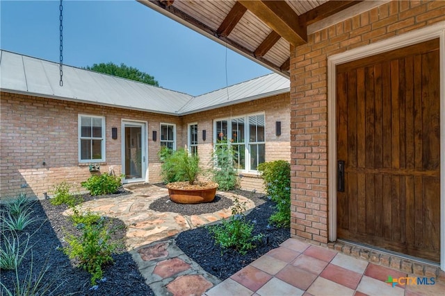 352 Ridge Crest Dr, Seguin, TX 78155 - property entrance with brick siding and metal roof
