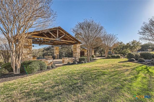 view of yard featuring a gazebo, a ceiling fan, and a patio area