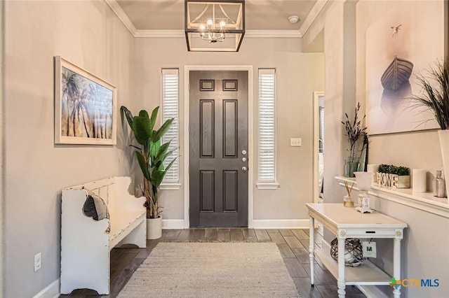 entrance foyer featuring a chandelier, baseboards, ornamental molding, and wood tiled floor