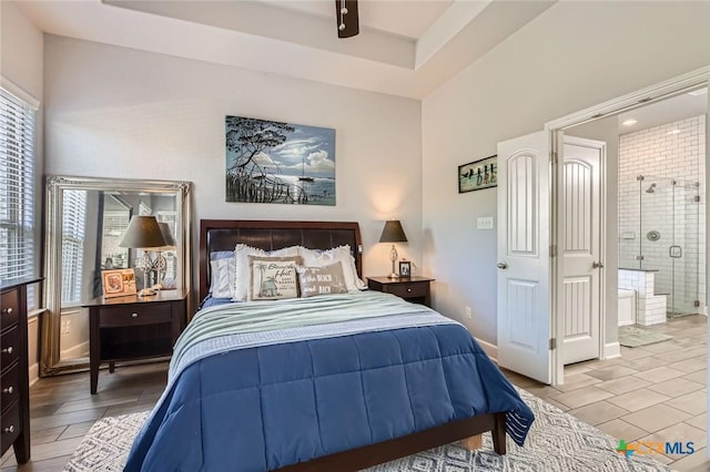 bedroom with ensuite bath, wood finish floors, and a ceiling fan