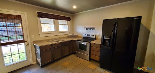 kitchen with sink, light tile patterned floors, ornamental molding, black fridge, and stainless steel range with electric cooktop