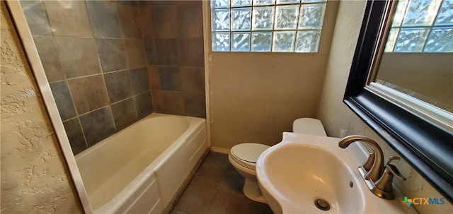 bathroom with tile patterned flooring, plenty of natural light, sink, and toilet