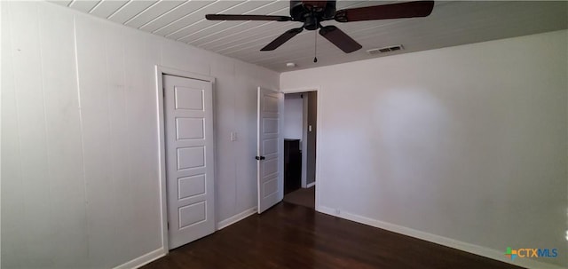 empty room with dark hardwood / wood-style flooring