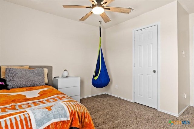 carpeted bedroom featuring a ceiling fan and baseboards