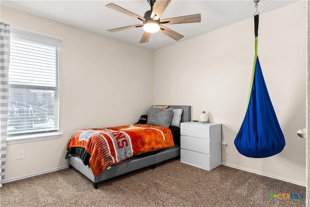 carpeted bedroom with multiple windows and ceiling fan