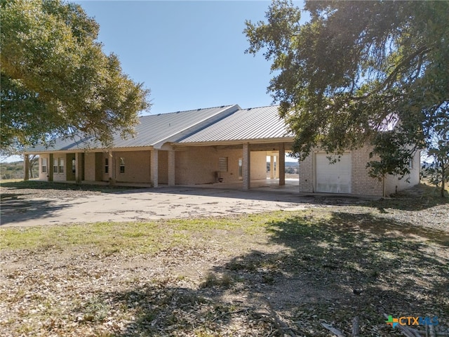 back of house featuring a garage