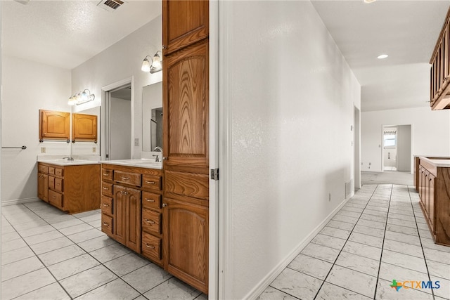 bathroom with tile patterned flooring and vanity