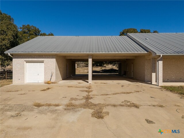 view of front facade with a carport and a garage