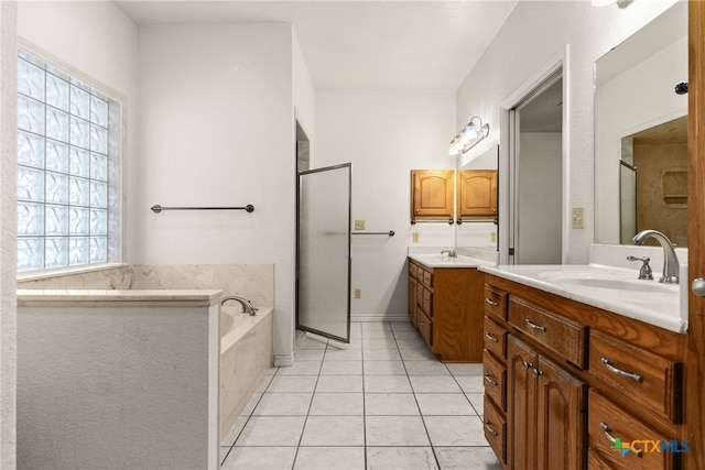 bathroom with tile patterned flooring, shower with separate bathtub, and vanity