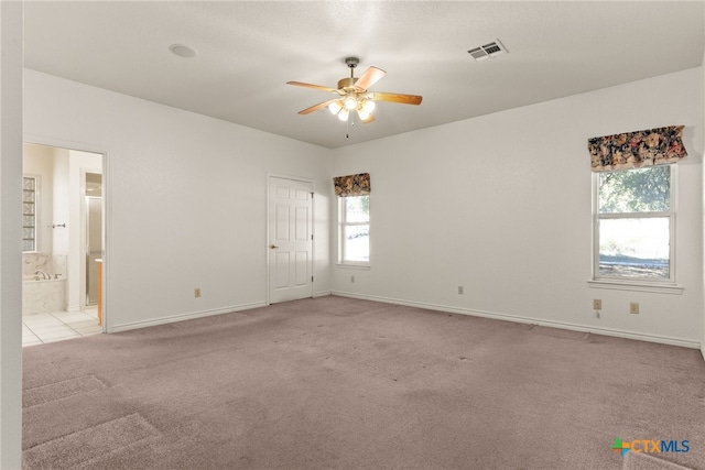 carpeted empty room featuring ceiling fan