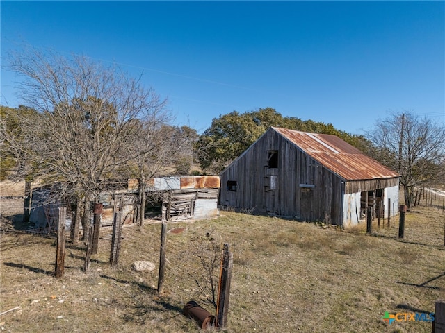 view of home's exterior with an outbuilding