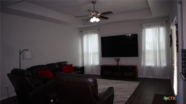 327 Limestone Crk, New Braunfels, TX 78130 - living room with a raised ceiling, a ceiling fan, and dark wood-style floors