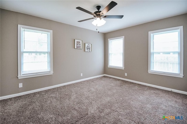 unfurnished room with baseboards, carpet, and a ceiling fan