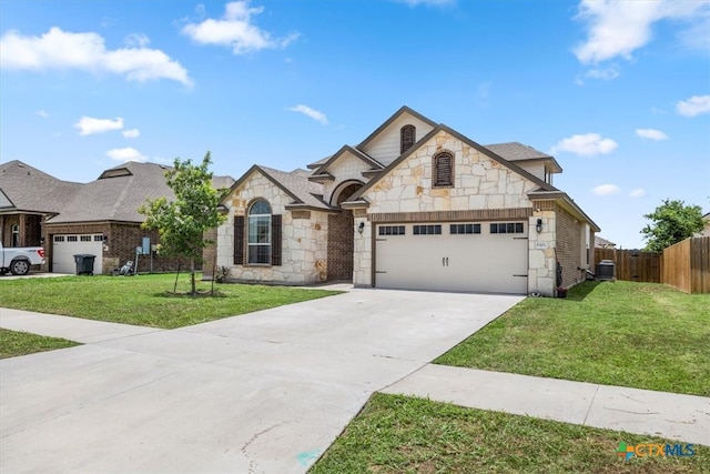 view of front of home with a front yard, a garage, and central AC unit