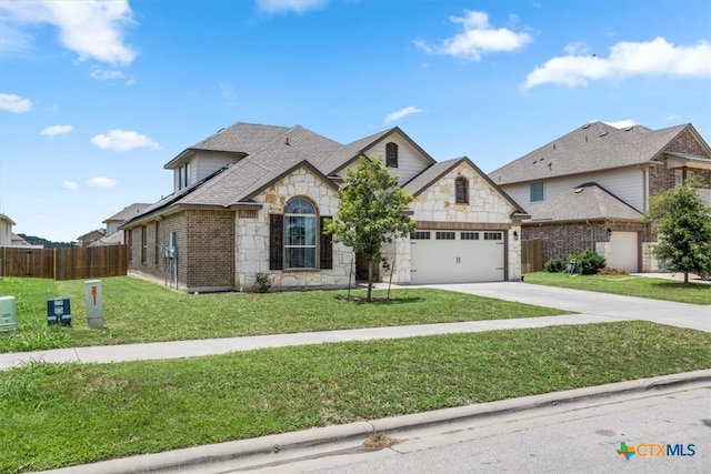 view of front of home featuring a front yard and a garage