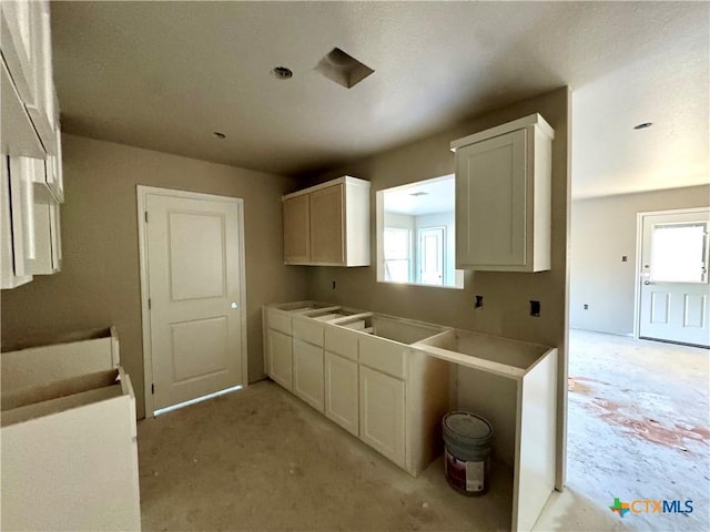 kitchen with white cabinetry and a healthy amount of sunlight