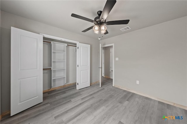 unfurnished bedroom with visible vents, a closet, baseboards, and light wood-style floors