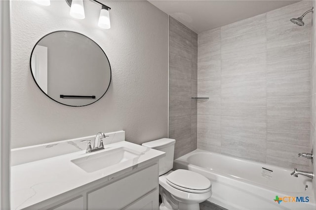 bathroom featuring bathtub / shower combination, a textured wall, toilet, and vanity