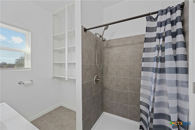 bathroom with a shower with curtain and tile patterned flooring