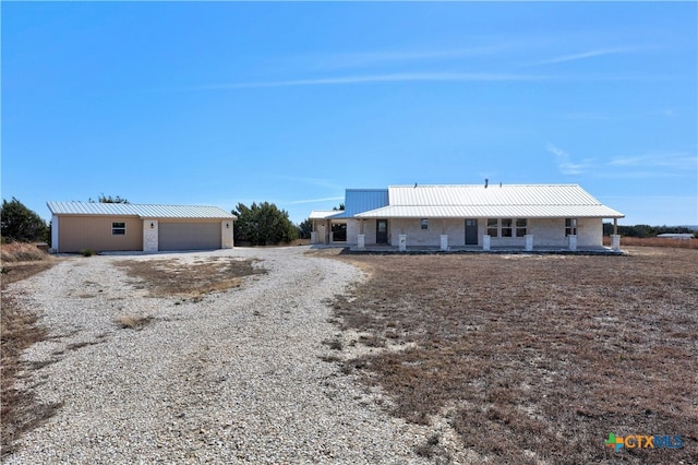 ranch-style house featuring a garage and a porch