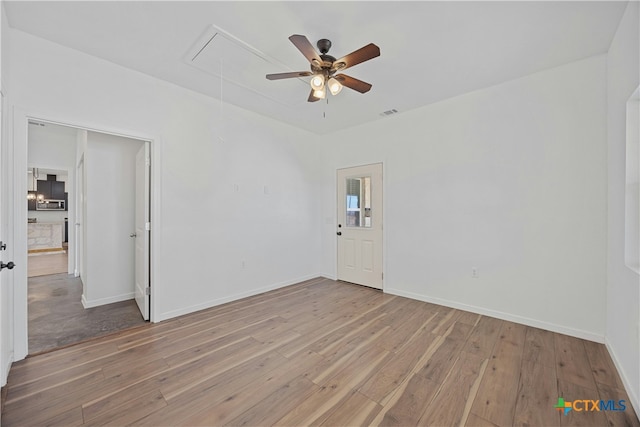 spare room featuring ceiling fan and light wood-type flooring