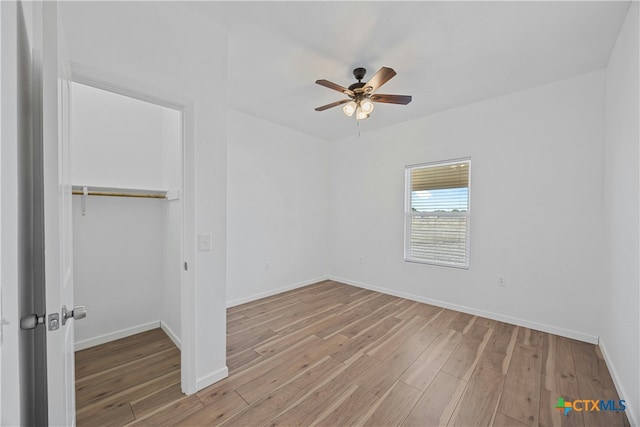 empty room featuring light hardwood / wood-style flooring and ceiling fan