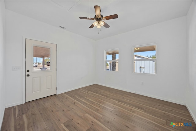 spare room with wood-type flooring and ceiling fan